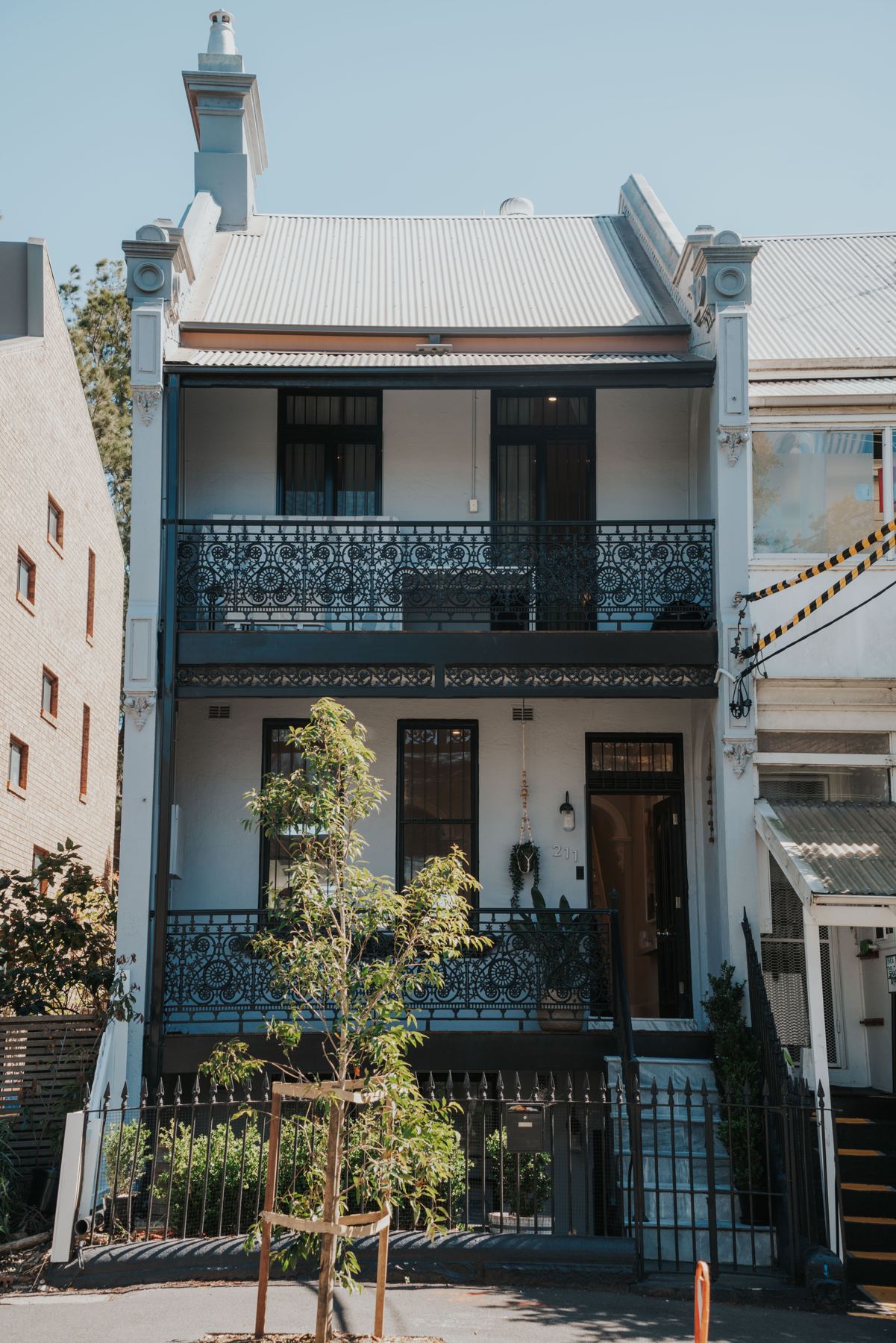 Restored terrace façade with cast-iron balcony and new paintwork